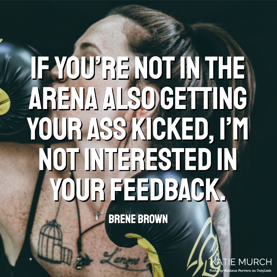Quote is in front of a freckled light-skinned woman with brown hair pulled into a ponytail. She kisses her boxing gloves to the left. A tattoo of a birdcage with a bird flying out and a quote is visible on her chest. Katie Murch and photo credit is on the bottom right of the image.