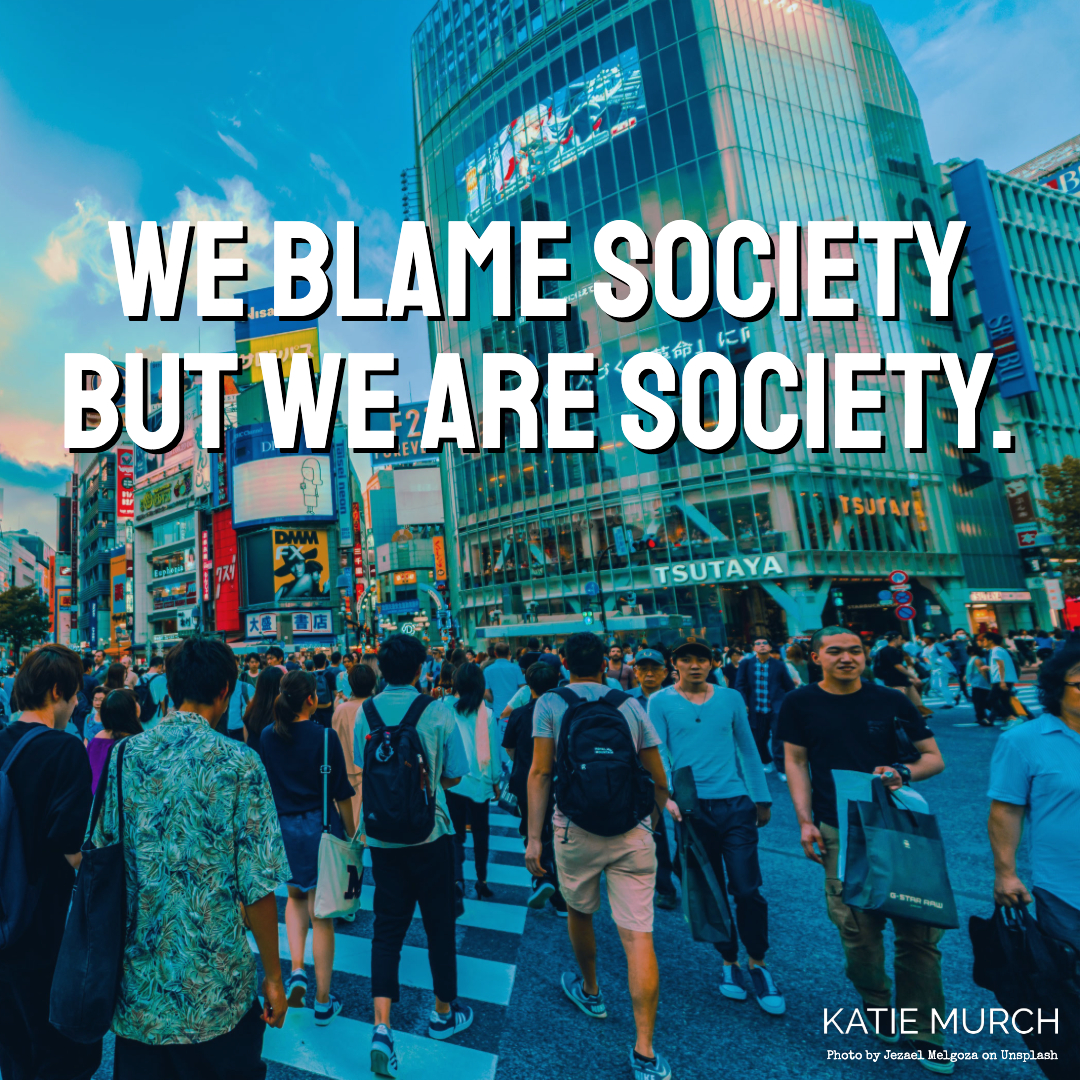 Quote is in front of a busy downtown crosswalk in an Asian town. Tall buildings and advertisements are seen in the back while people holding shopping bags, totes, and backpacks are walking towards and away from the viewer. Katie Murch and photo credit is on the bottom right of the image.