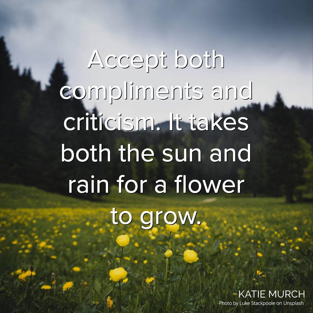 Quote is in front of a green field with yellow flowers in the front and pine trees in the back. A gray sky is above. Katie Murch and photo credit is on the bottom right of the image.