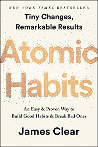 Book is light yellow-white with "Atomic Habits" in gold and "New York Times Bestseller," "Tiny Changes, Remarkable Results," "An Easy & Proven Way to Build Good Habits & Break Bad Ones," and "James Clear" in black. All text are centered.